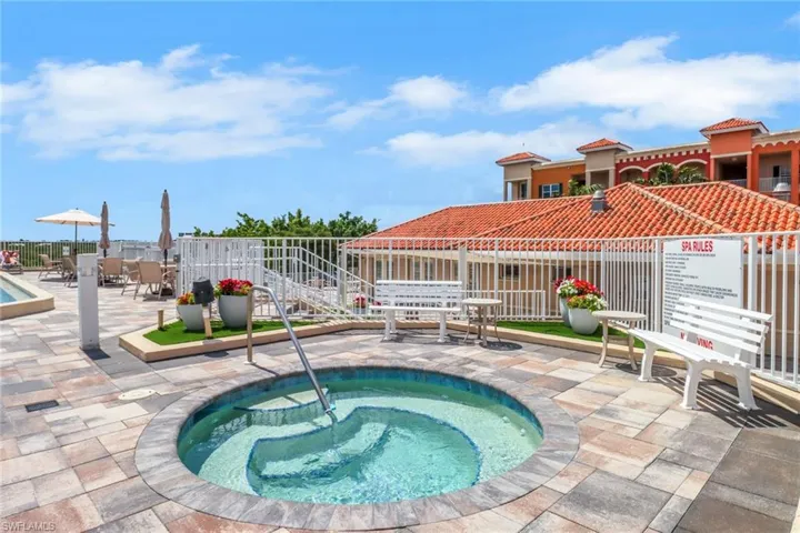 View of pool with a hot tub, a swimming pool, and a patio area