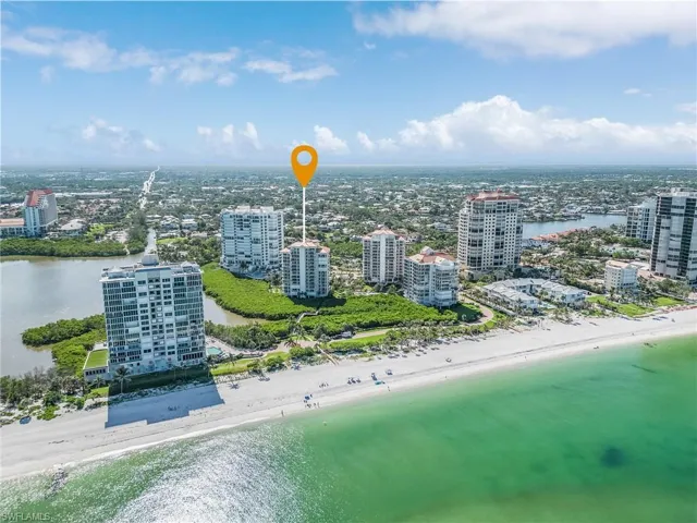 Drone / aerial view featuring a water view and a view of the beach