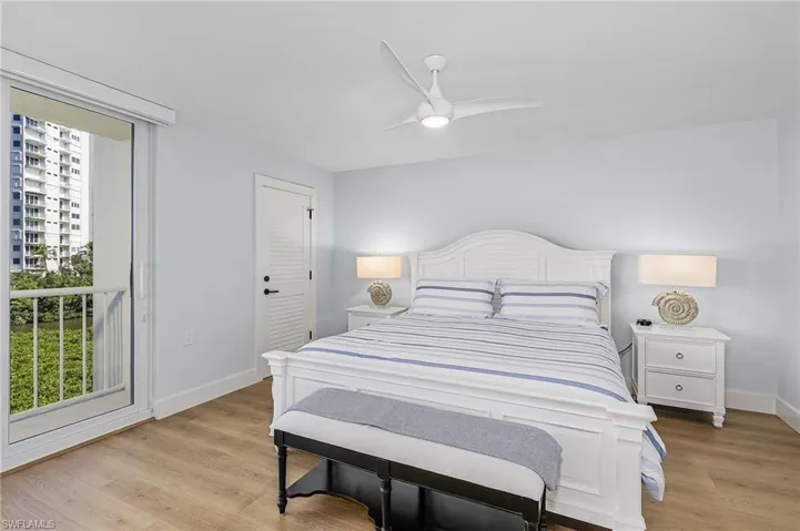 Bedroom with light hardwood / wood-style flooring, a closet, and ceiling fan