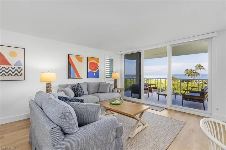 Living room featuring a water view and light wood-type flooring