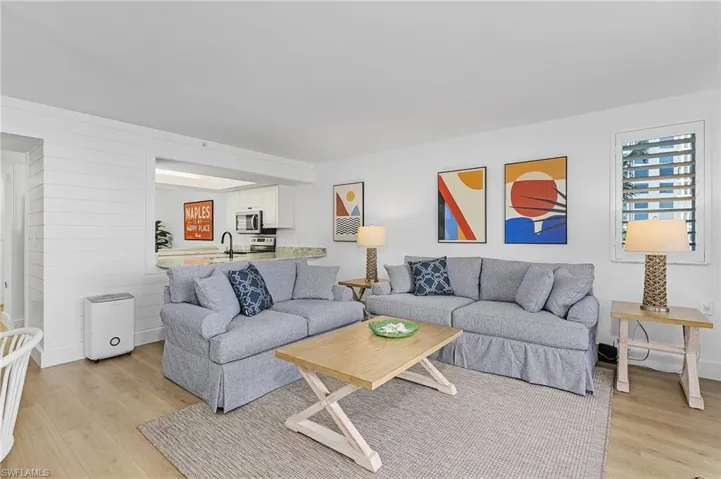 Living room with sink and light wood-type flooring