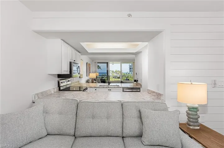 Living room featuring sink and a tray ceiling