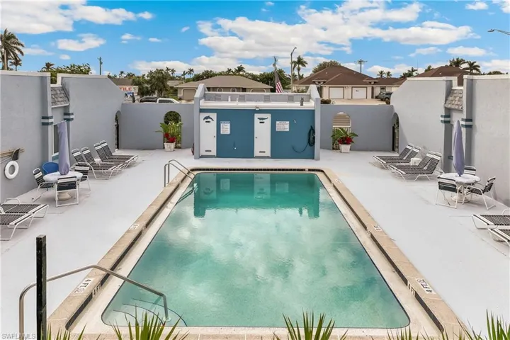 Community pool featuring a patio and a residential view