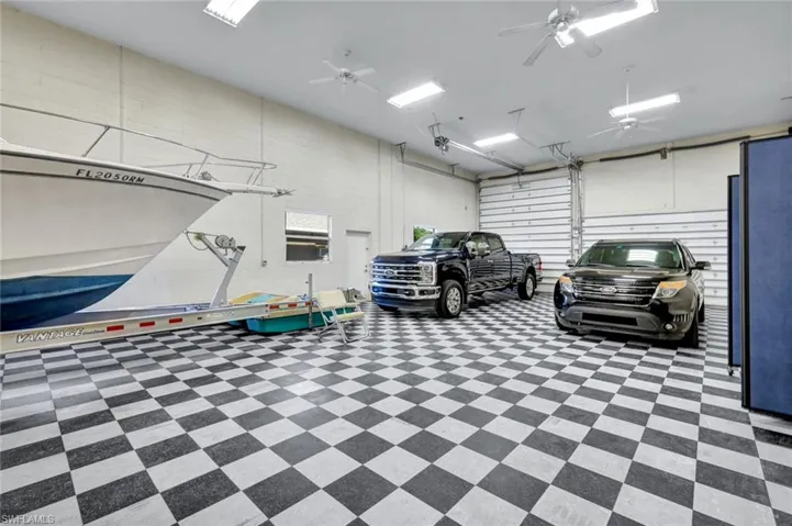 Expansive Temperature-Controlled Garage, can accommodate up to 10 cars or combo of RV, Boats and cars. Complete with a car lift, air compressor, workshop and 1/2 bathroom.