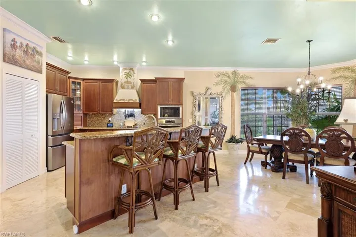 Spacious kitchen featuring granite countertops, wood cabinetry, stainless steel appliances, and recessed lighting