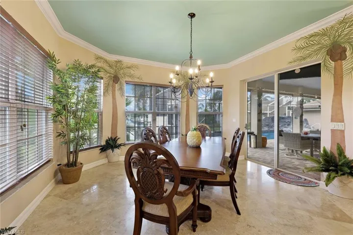Large Dining Area with crown molding, chandelier lighting, and a sliding glass door to the exterior