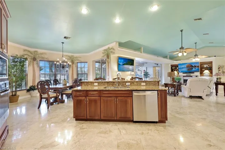 Spacious kitchen featuring granite countertops, wood cabinetry, stainless steel appliances, and recessed lighting