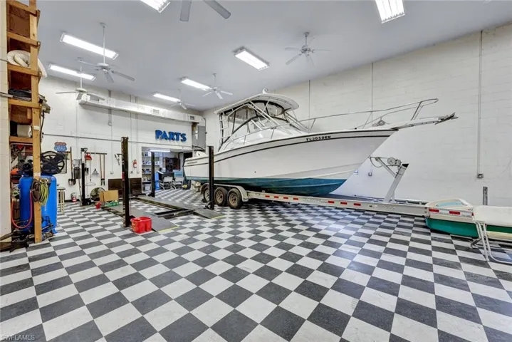 Massive Temperature-Controlled Garage, can accommodate up to 10 cars or combo of RV, Boats and cars. Complete with a car lift, air compressor, workshop and 1/2 bathroom.