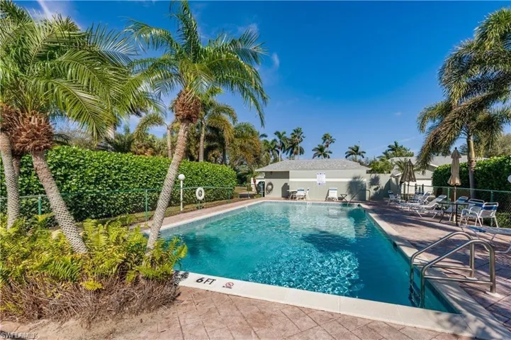 Community pool with a patio