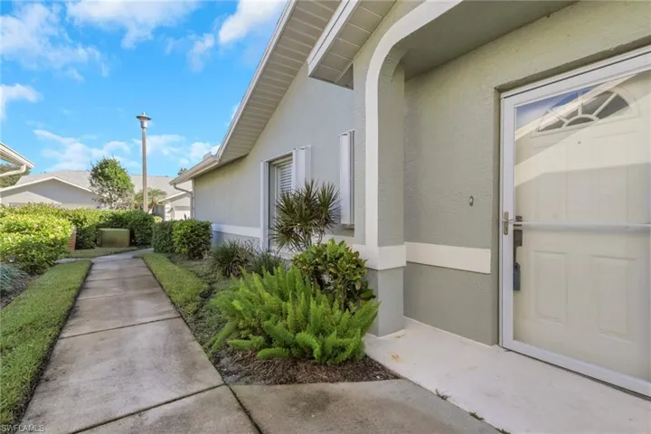 View of exterior entry with stucco siding