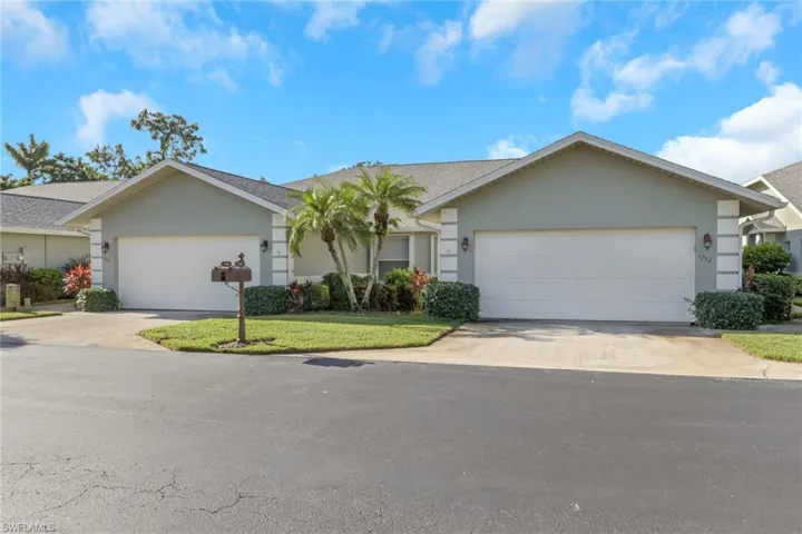 Ranch-style house with stucco siding, an attached garage, concrete driveway, and a front lawn