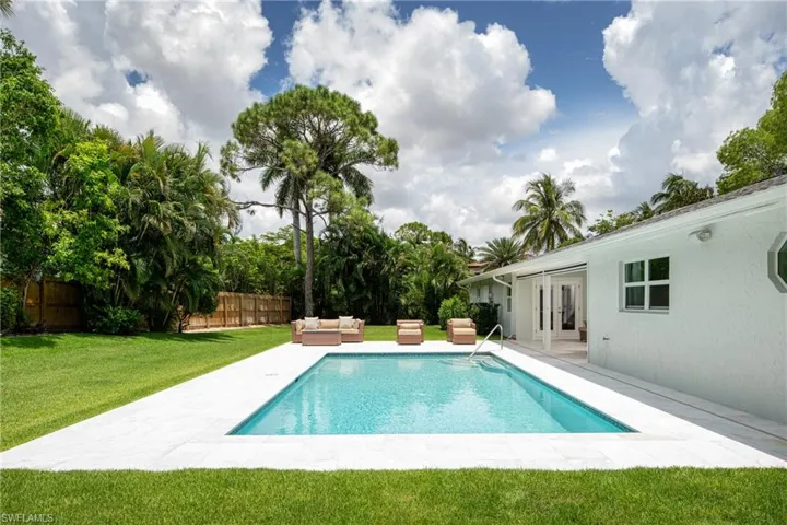View of pool with a patio, outdoor lounge area, french doors, and a fenced backyard