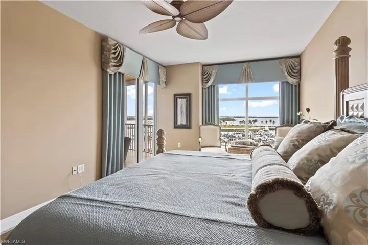 Master Bedroom with access to exterior, multiple windows, motorized blinds, ceiling fan and sliders to balcony overlooking the Marina