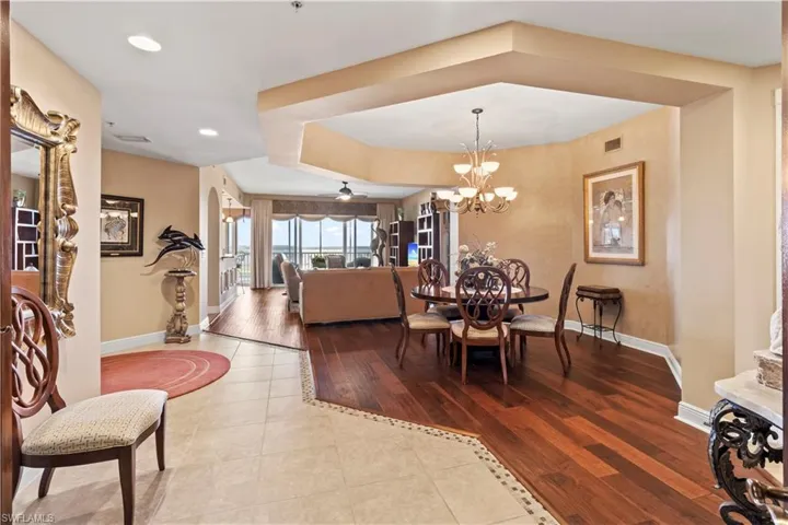 Dining area featuring tile patterned floors, a chandelier, and recessed lighting