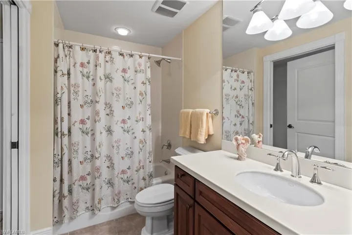 Bathroom #3 with vanity, tile patterned floors, and shower / bath combo