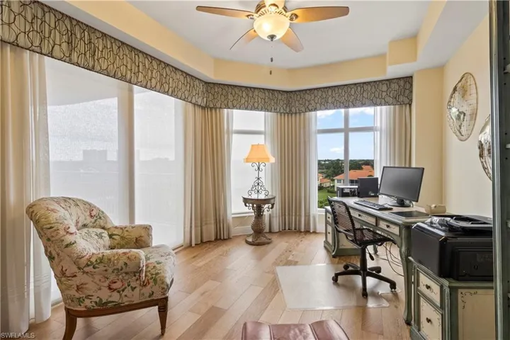 Office with a ceiling fan and light wood-style floors