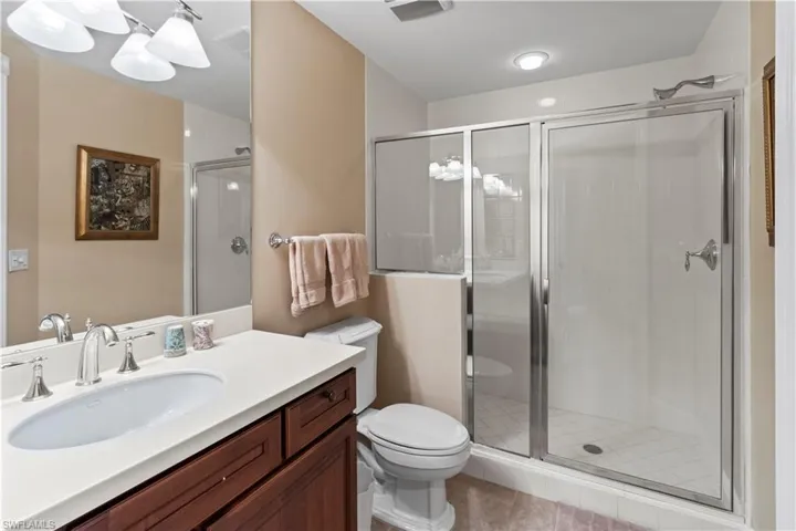Bathroom #2 with vanity, a stall shower, and tile patterned flooring