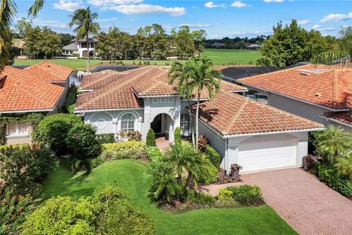 Mediterranean / spanish home with stucco siding, decorative driveway, a tile roof, and a front lawn
