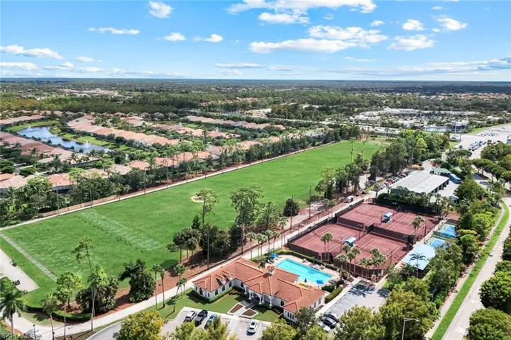 Aerial view of residential area with a pool and a nearby body of water