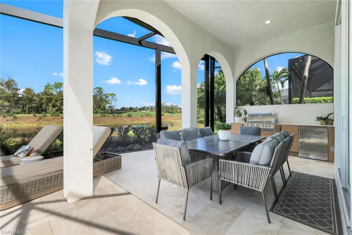 View of patio / terrace with outdoor dining area, an outdoor kitchen, and a water view