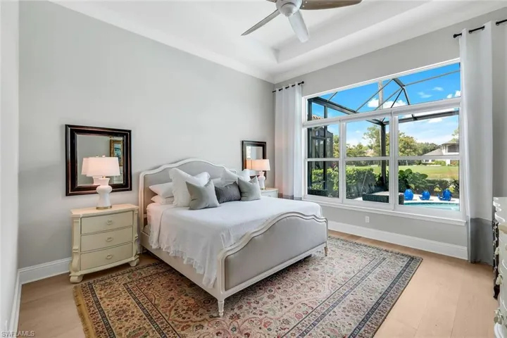 Bedroom featuring light wood finished floors, a ceiling fan, and a sunroom