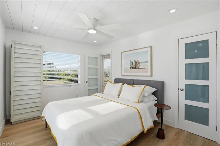 Bedroom with light wood-type flooring, a ceiling fan, and recessed lighting Virtually Edited