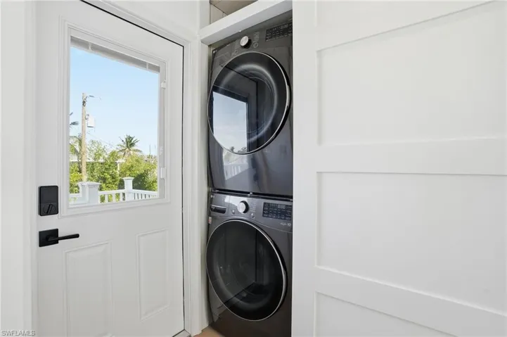 Laundry area featuring estacked washer and dryer Virtually Edited