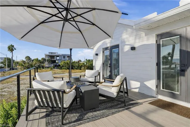 Wooden terrace with an outdoor living space with a fire pit