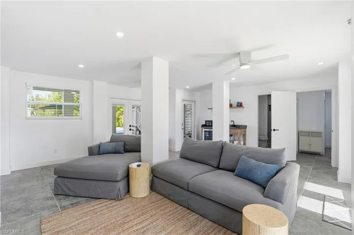 Living area with recessed lighting, french doors, and ceiling fan Virtually Edited