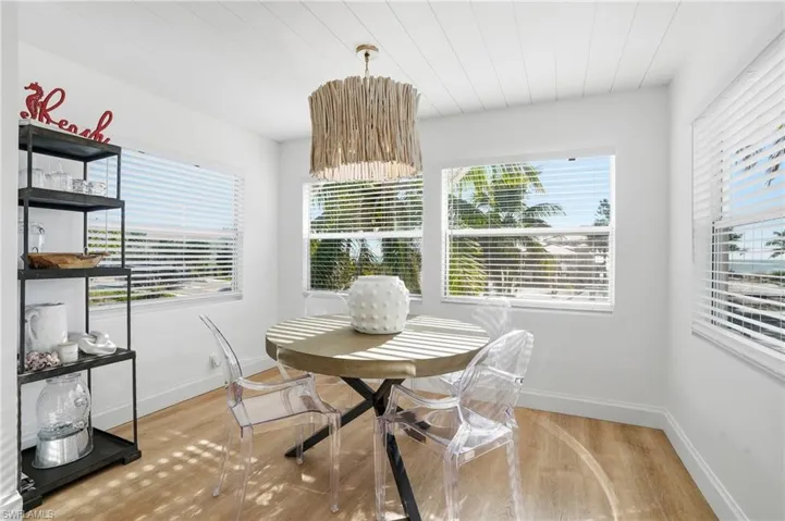 Dining space with light wood finished floors and wooden ceiling Virtually Edited