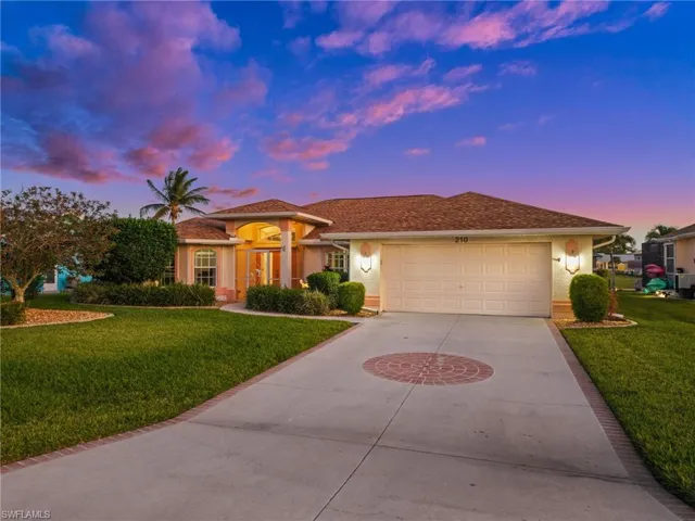 Mediterranean / spanish-style home with a lawn, concrete driveway, stucco siding, and a garage