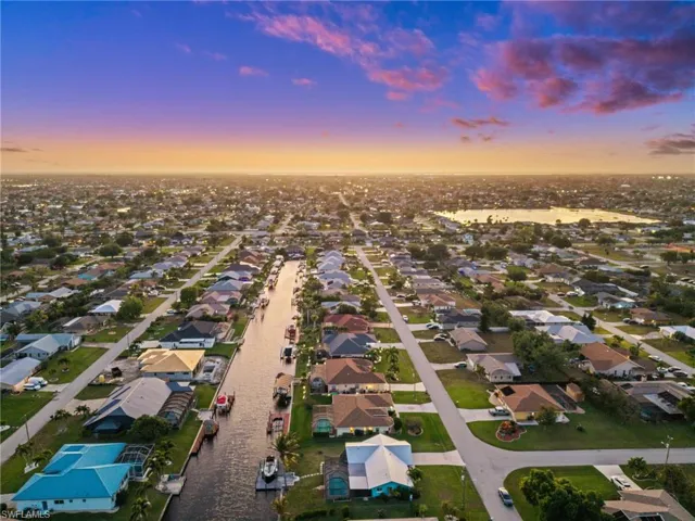 Aerial perspective of suburban area featuring a nearby body of water