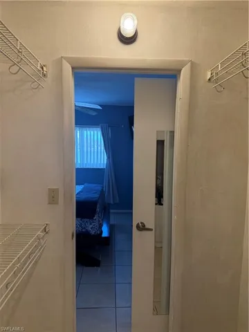 Hall featuring tile patterned floors