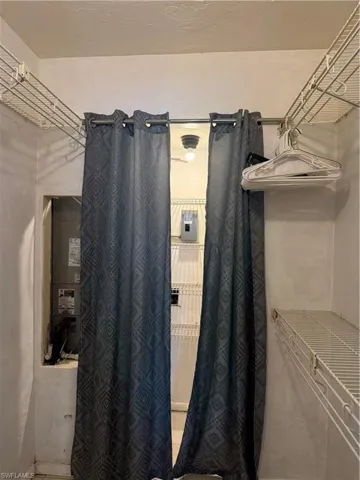 Full bathroom featuring heating unit and curtained shower
