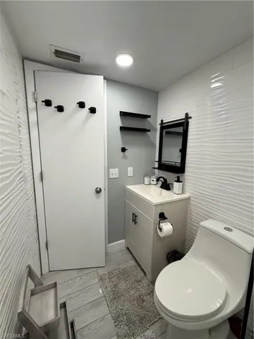 Bathroom with tile walls and vanity