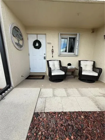 Doorway to property with stucco siding