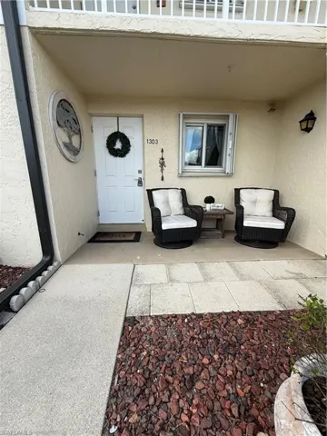 Property entrance featuring stucco siding