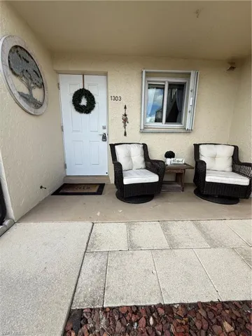 Entrance to property with stucco siding