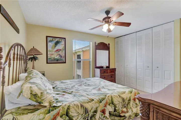 Bedroom featuring a textured ceiling, a closet, and ceiling fan
