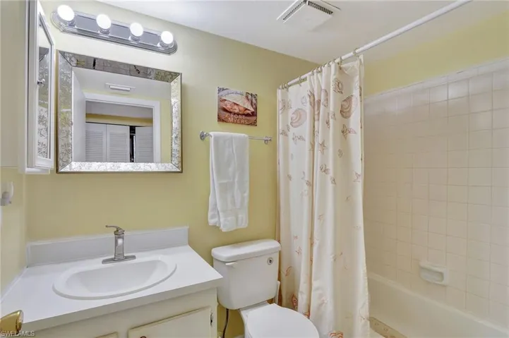 Full bathroom featuring shower / bath combo, toilet, and vanity