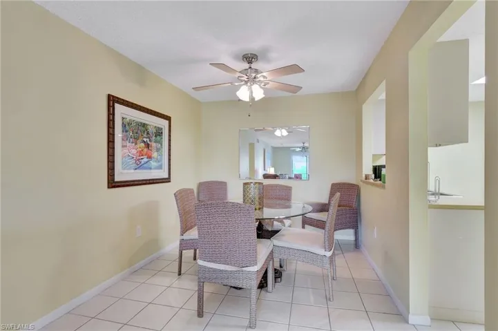 Tiled dining area with sink and ceiling fan