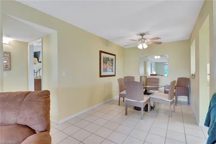 Dining room featuring light tile patterned floors and ceiling fan