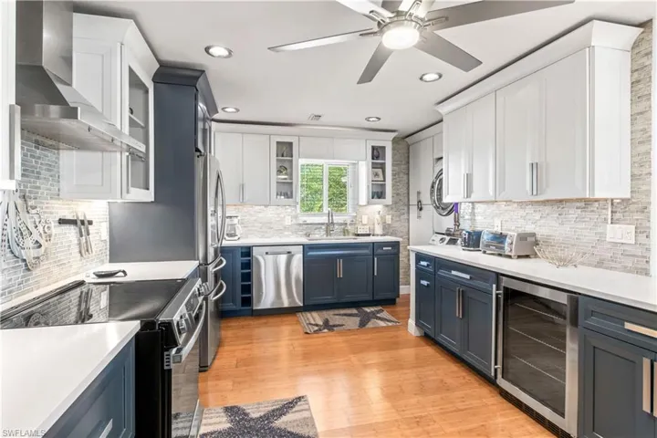 Stainless steel appliances, Corian countertops, custom cabinetry, and a wine fridge—perfect for hosting family and friends.