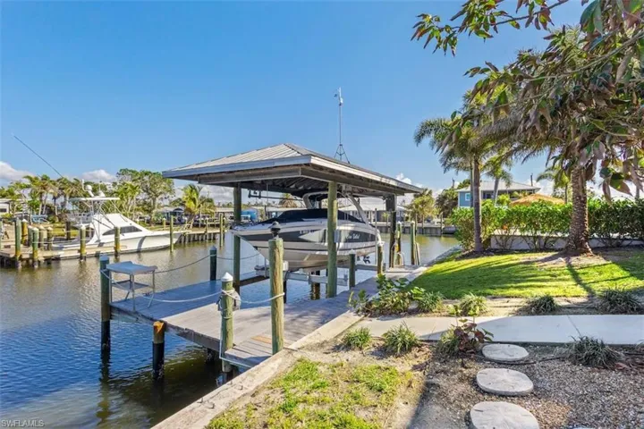 Covered dock with lift—your gateway to the Gulf and beyond.