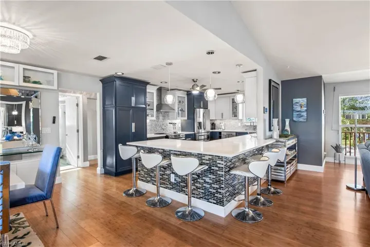 Gather around the large island and enjoy the perfect flow from kitchen to living space to outdoor patio.  Everything has been updated and designed to enjoy living and entertaining in an open space filled with natural light!