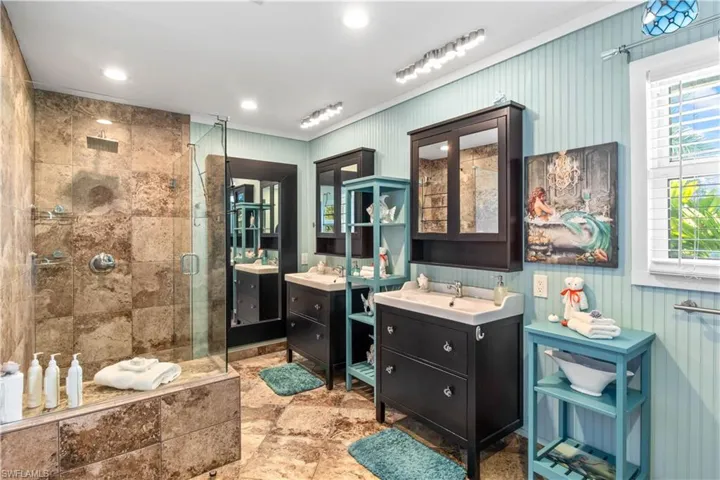A spa within your own home!  Double vanities, travertine tile, walk in shower and beautiful wainscotting.