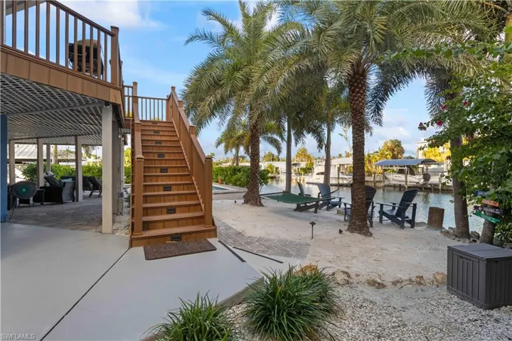 Resort-Style Outdoor Oasis: Dive into the heated pool, unwind by the firepit, or swing lazily in the hammock under the palms.  Your own private beach!!!!!!!!!!
