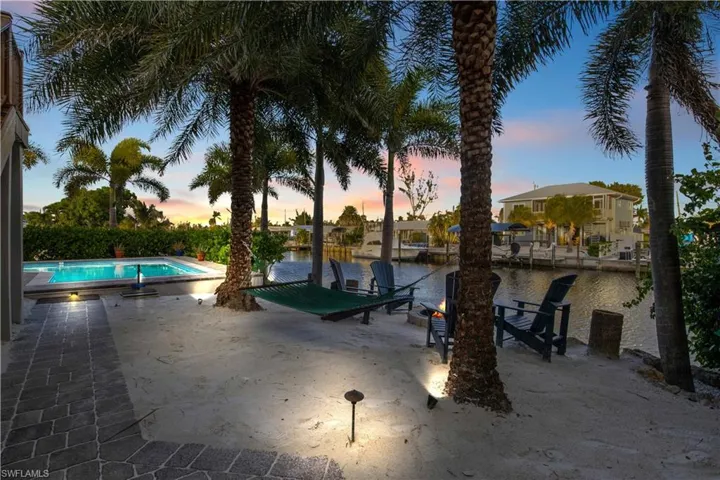 An oversized custom pool that is both heated and salt water!  Beautiful night lighting showcases the palms and landscaping!