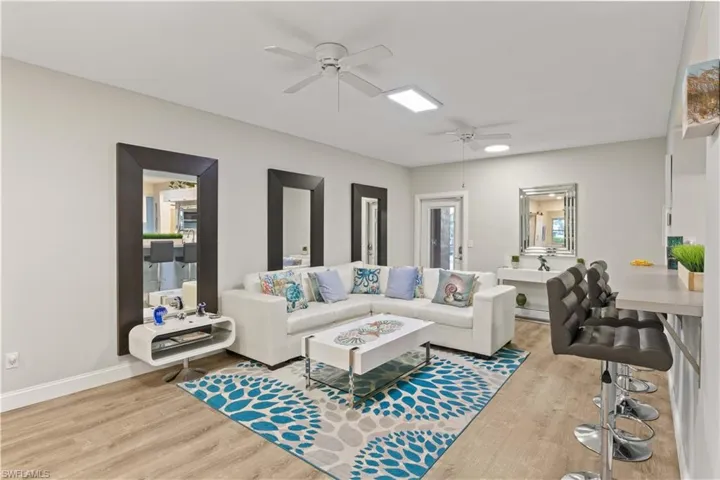 Another view of the downstairs living space with lots of natural light, beautiful flooring and gorgeous furniture - this home comes turn key and sold as you see it!  Just bring your toothbrush and clothes!