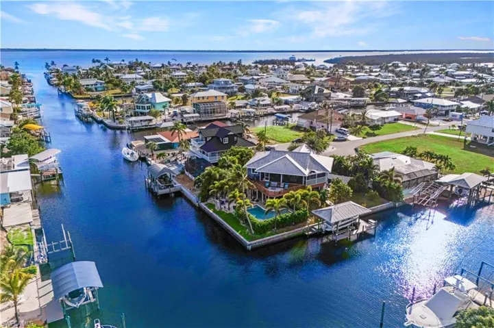 Your Private Waterfront Paradise Awaits! Nestled on a peaceful cul-de-sac, this tropical retreat boasts 189 feet of intersecting canal frontage—where every sunrise and sunset paints the water in gold.  Easy access directly out to the Gulf!